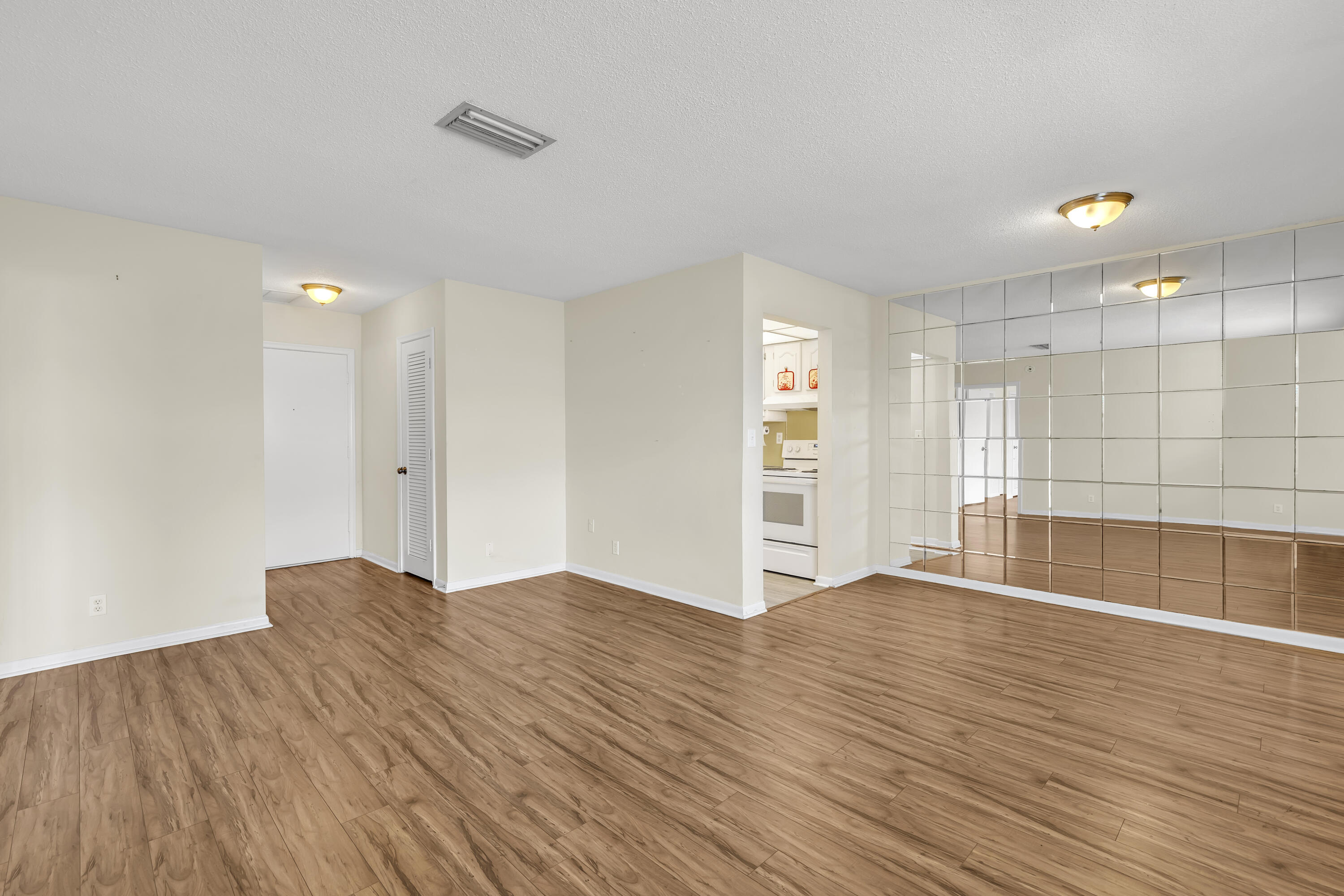 298 Southwest 6th Street, Unit 204 Boca Raton, FL 33432 - Photo 10 of 22 a view of an empty room with wooden floor and a window