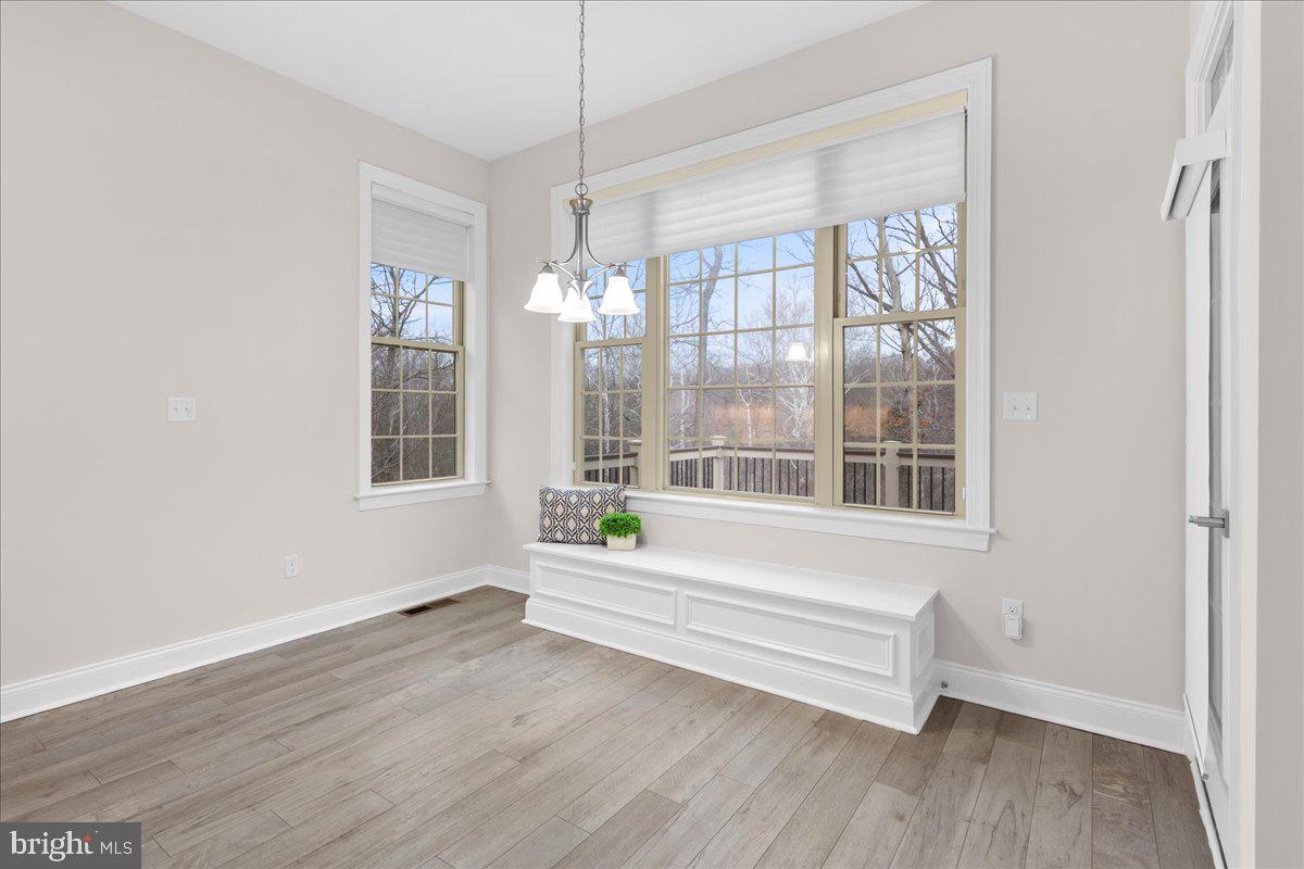 13712 Long Ridge Drive Gainesville, VA 20155 - Photo 14 of 62 a view of wooden floor and windows in a room