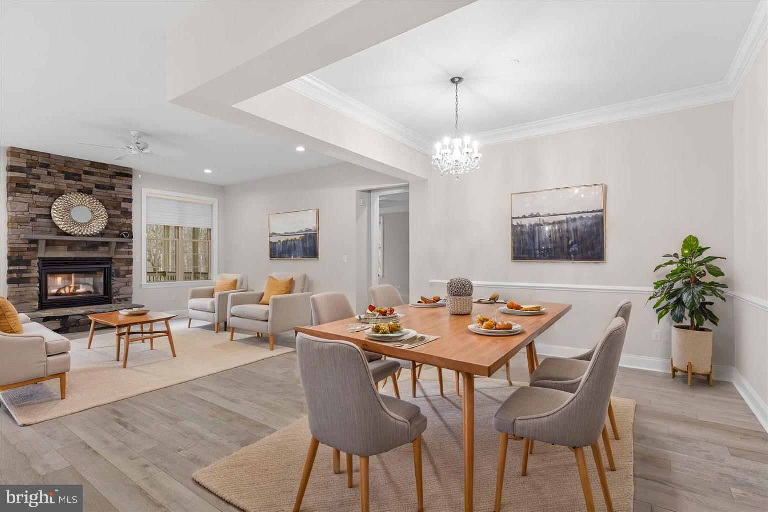 13712 Long Ridge Drive Gainesville, VA 20155 - Photo 15 of 62 a dining room with wooden floor a chandelier a glass table and chairs