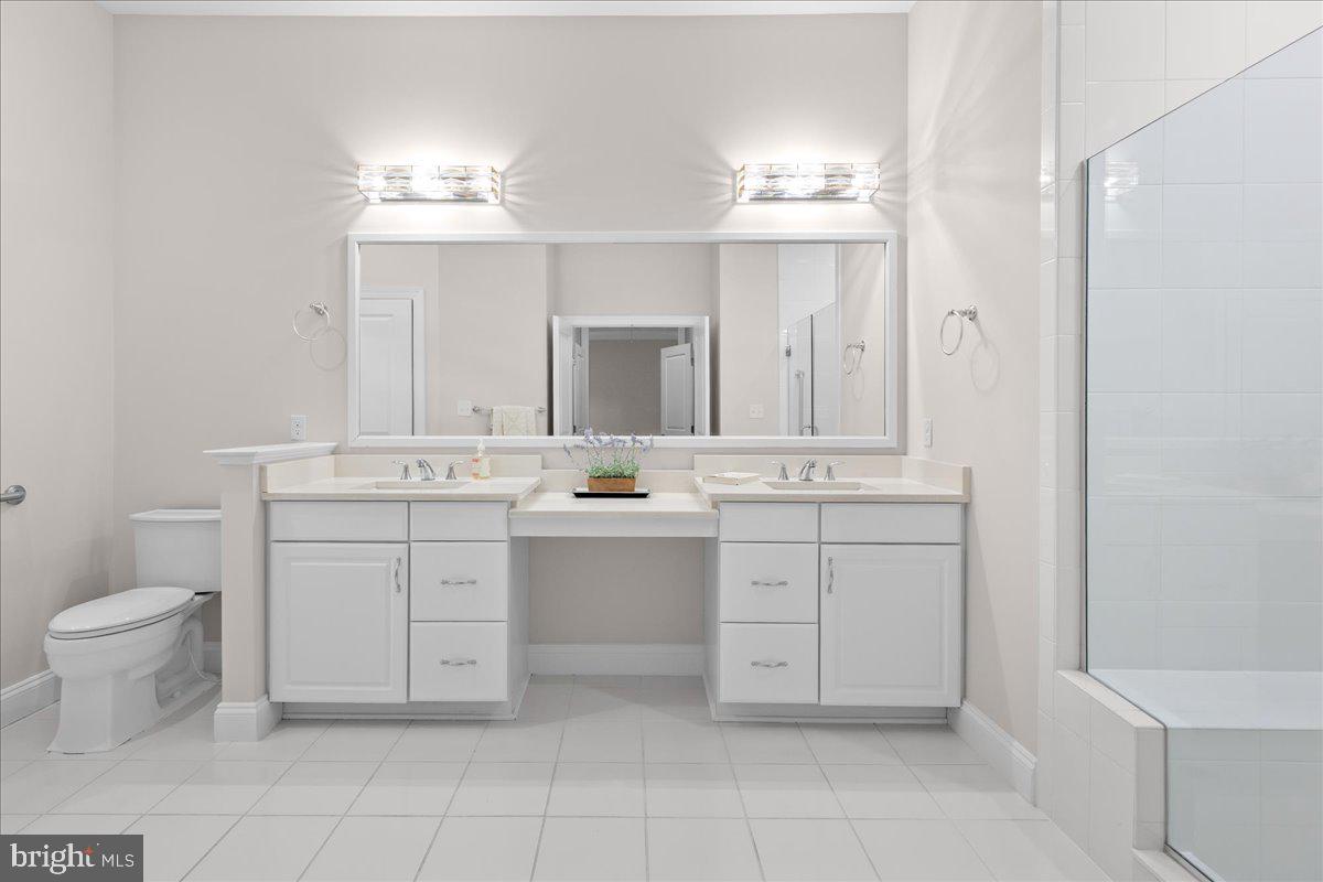 13712 Long Ridge Drive Gainesville, VA 20155 - Photo 20 of 62 a bathroom with a double vanity sink a toilet and a mirror