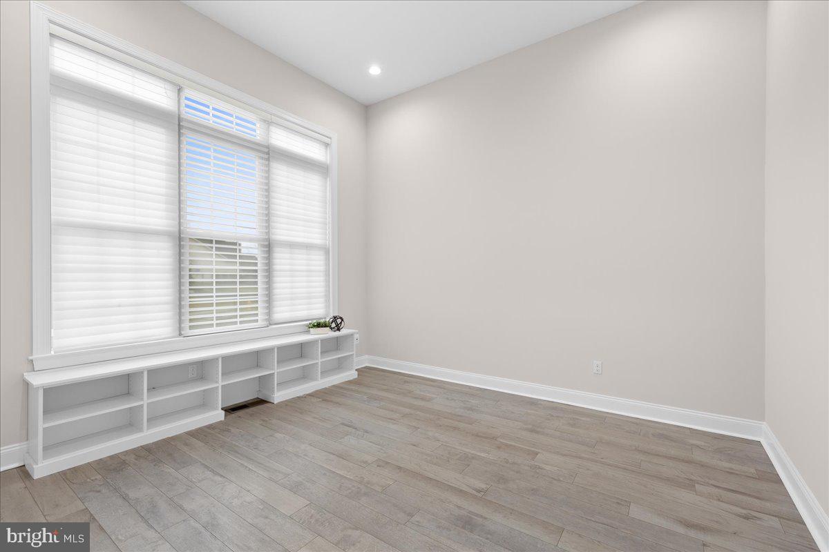 13712 Long Ridge Drive Gainesville, VA 20155 - Photo 28 of 62 a view of an empty room with wooden floor and a window