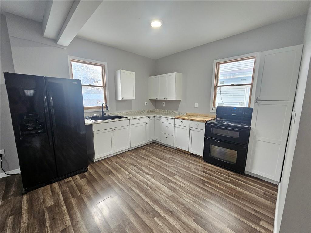 418 Short Street Donora, PA 15033 - Photo 7 of 22 a kitchen with a sink a refrigerator a window and cabinets