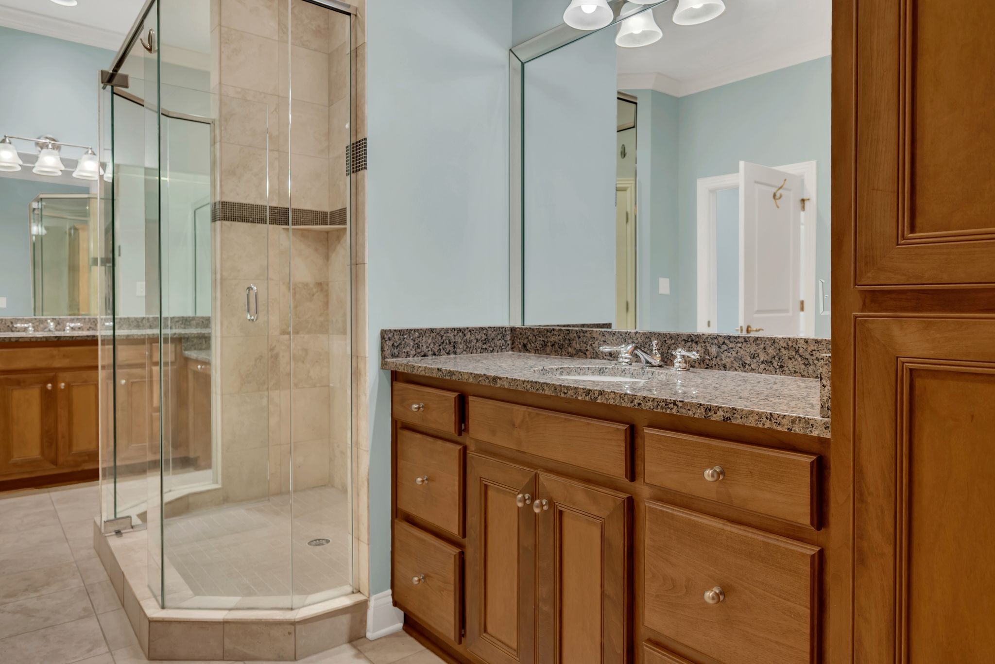 2411 Crestmoor Road, Unit 104 Nashville, TN 37215 - Photo 24 of 32 a bathroom with a granite countertop sink a mirror and a bathtub