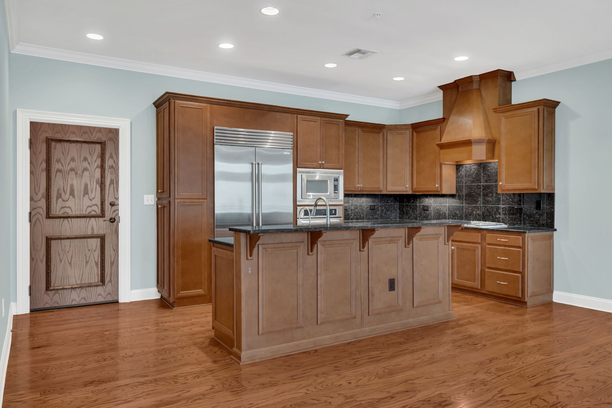 2411 Crestmoor Road, Unit 104 Nashville, TN 37215 - Photo 9 of 32 a kitchen with stainless steel appliances granite countertop a refrigerator and a stove top oven