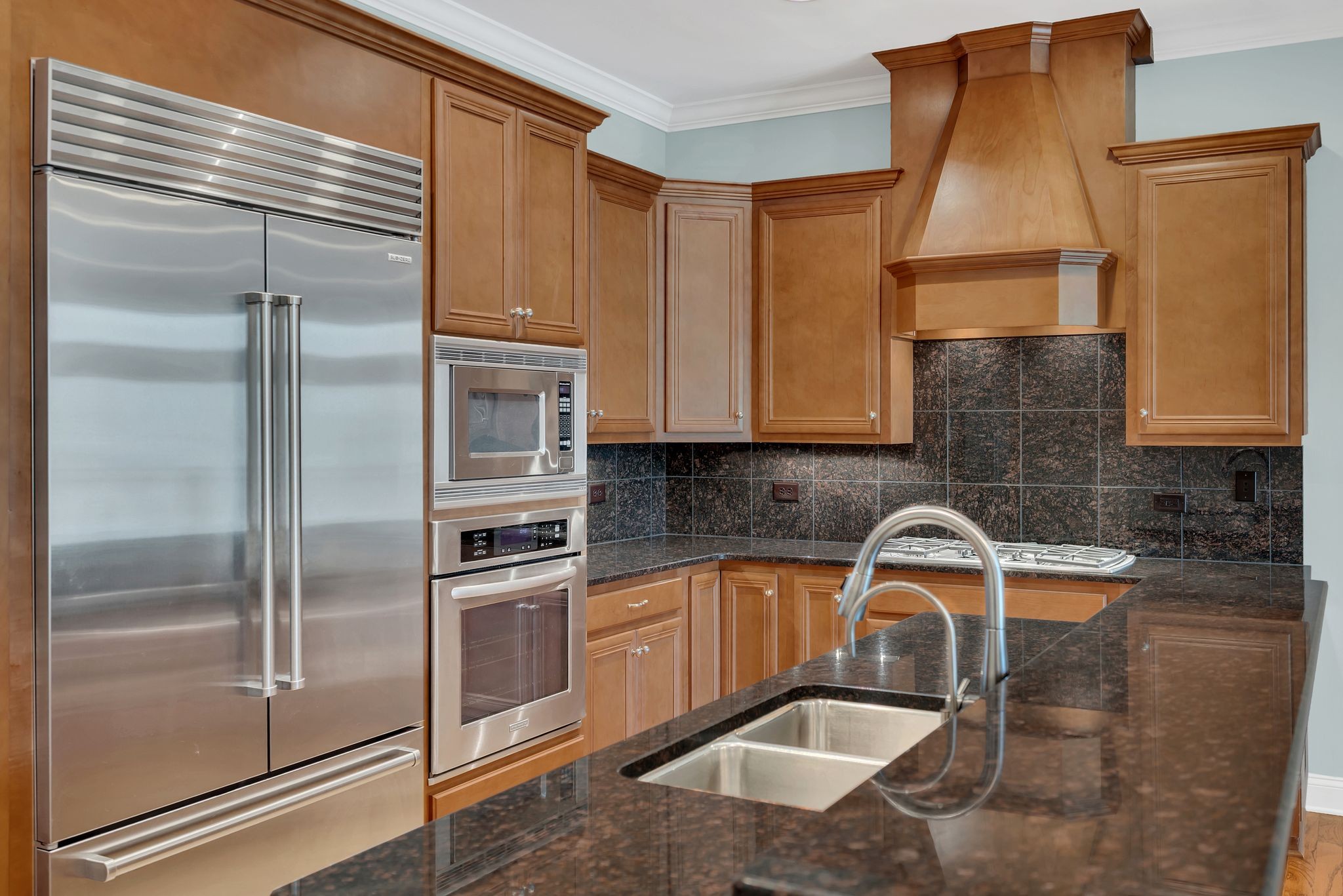 2411 Crestmoor Road, Unit 104 Nashville, TN 37215 - Photo 10 of 32 a kitchen with a sink a refrigerator and cabinets