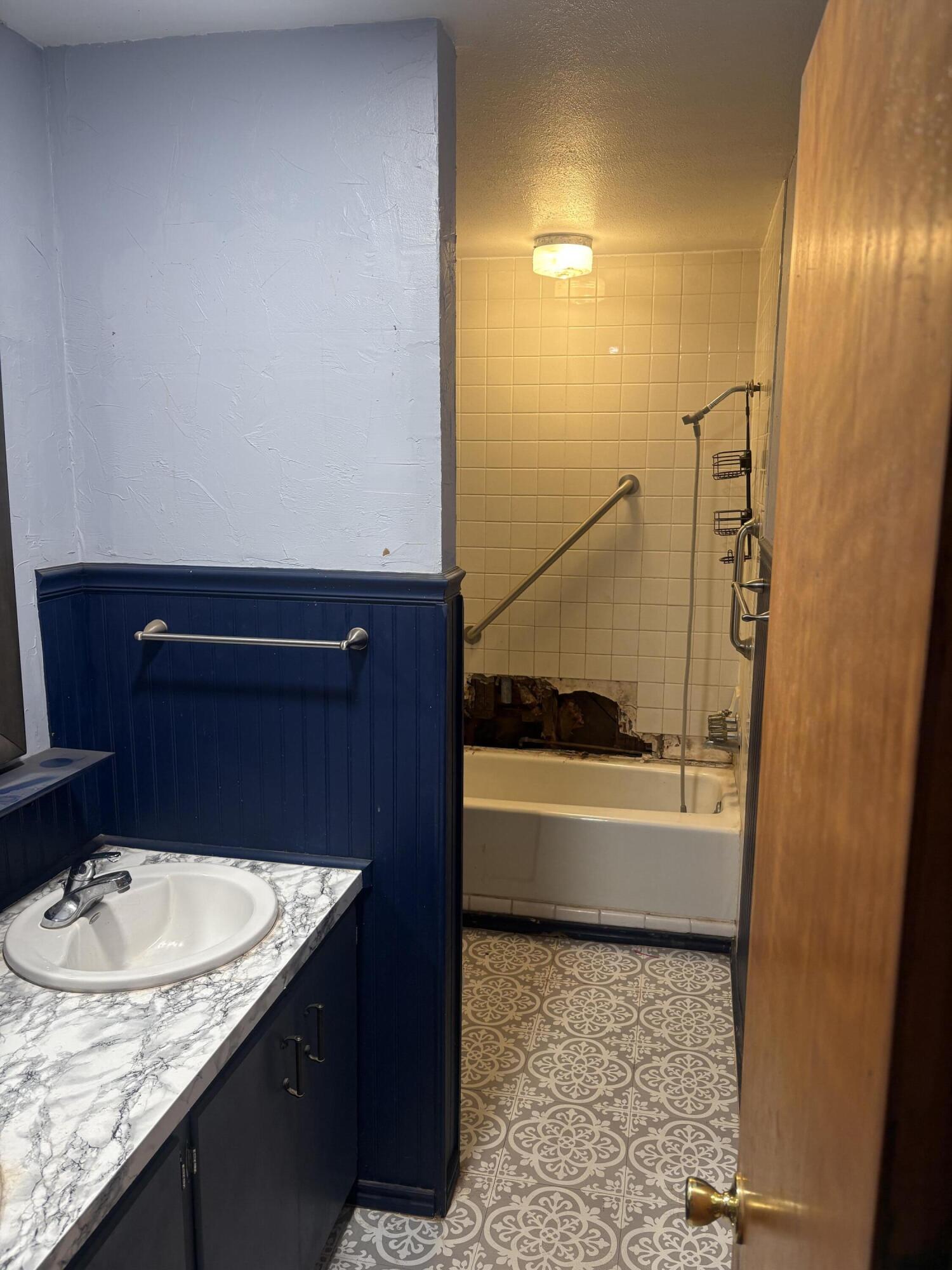 2009 46th Street Lubbock, TX 79412 - Photo 17 of 41 a bathroom with a granite countertop sink and a mirror