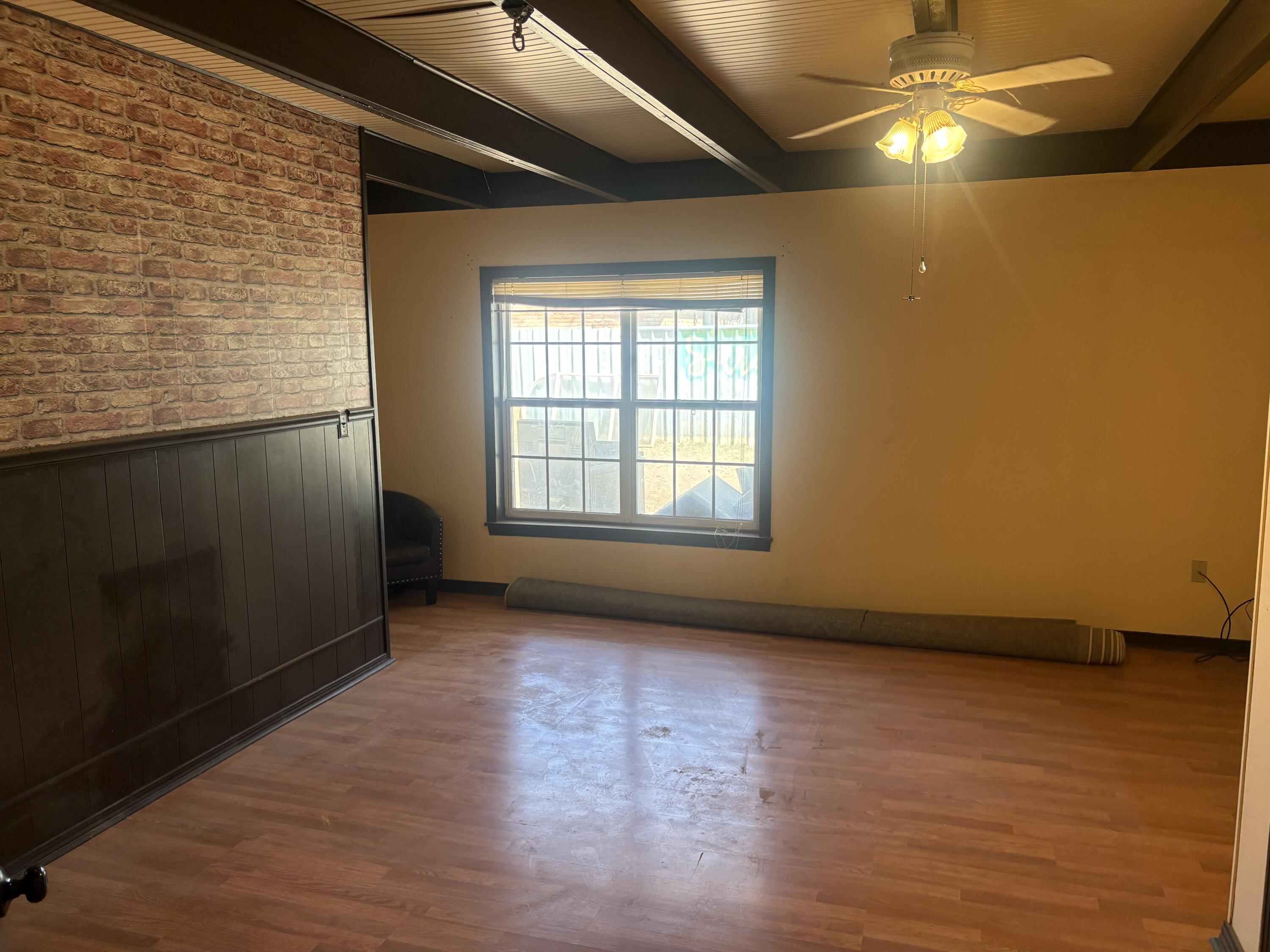 2009 46th Street Lubbock, TX 79412 - Photo 23 of 41 a view of an empty room with wooden floor and a window