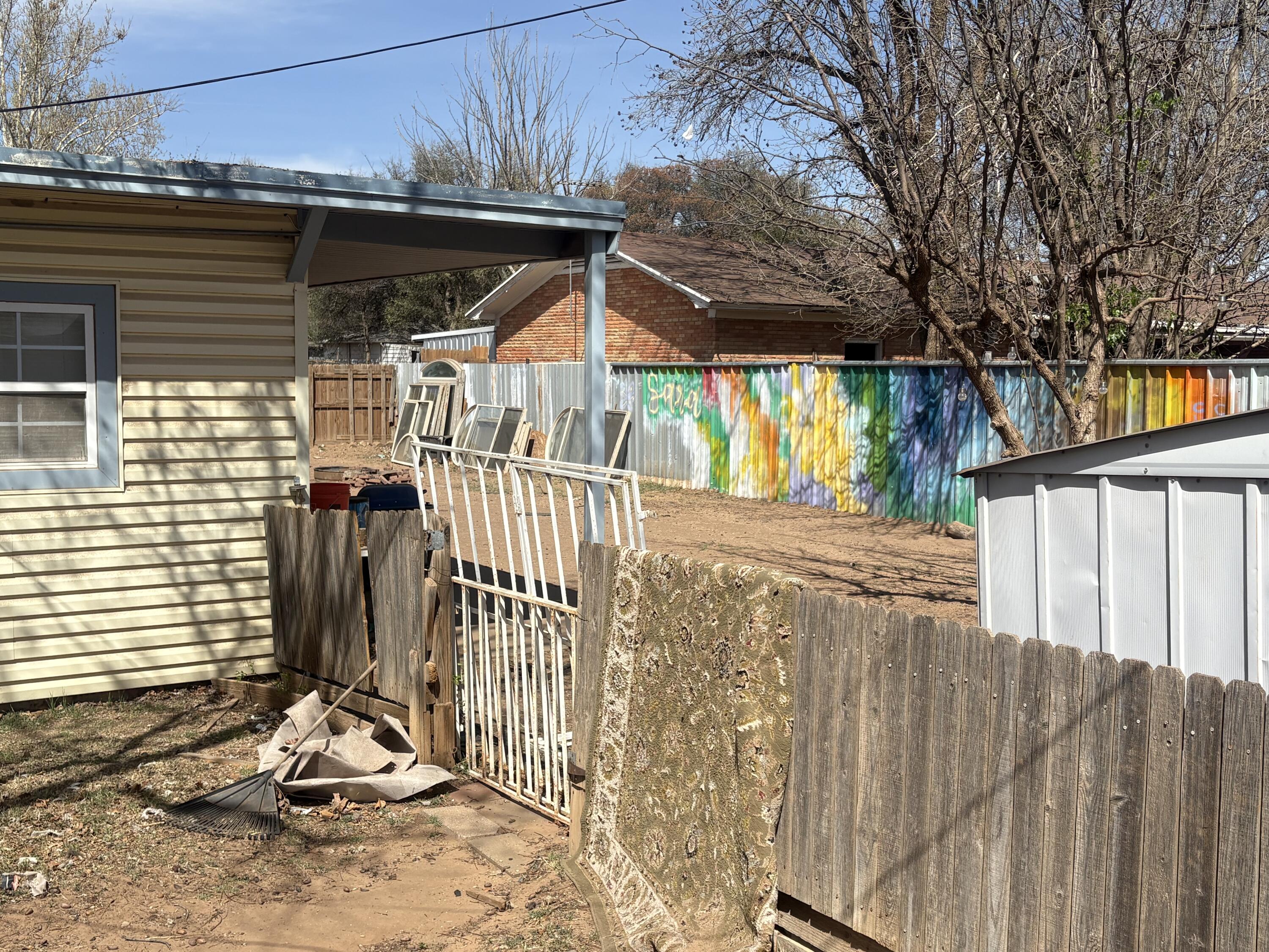 2009 46th Street Lubbock, TX 79412 - Photo 36 of 41 a view of a backyard with a small cabin and wooden fence