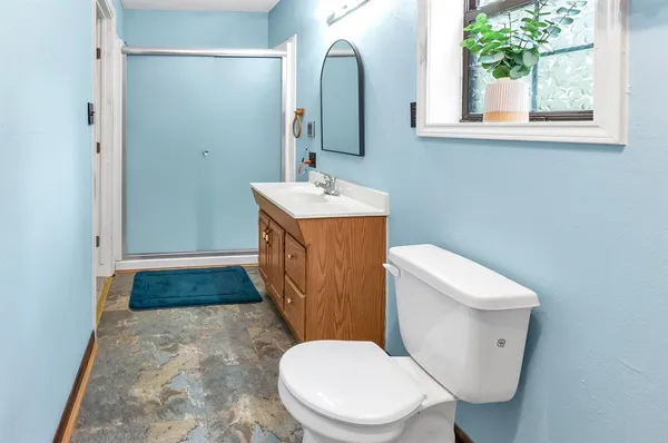 a white toilet sitting next to a bathroom sink
