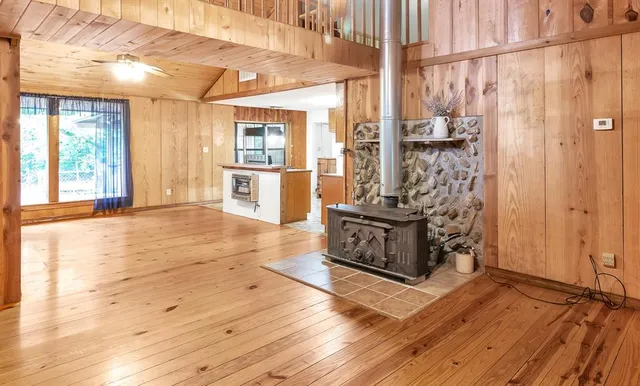 a kitchen with stainless steel appliances kitchen island wooden floors and wooden cabinets