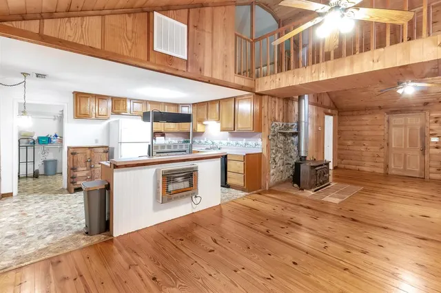 a kitchen with stainless steel appliances granite countertop a sink a stove and cabinets