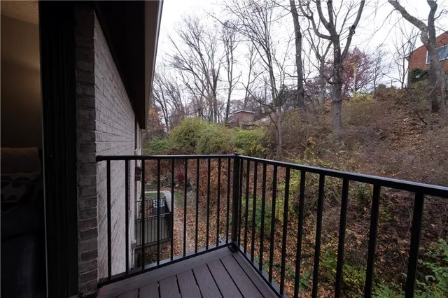 a balcony with wooden floor and fence