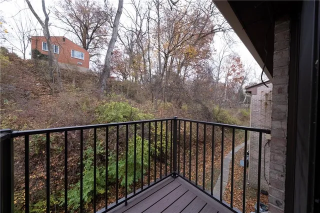 a view of balcony with wooden floor