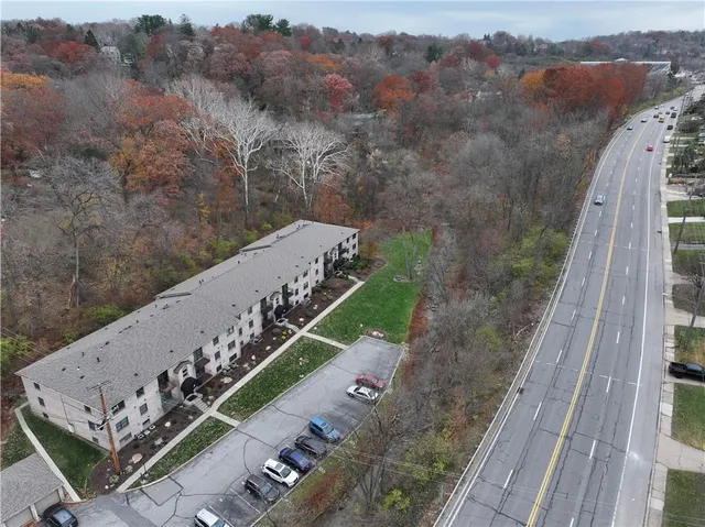 a view of a city with lush green forest