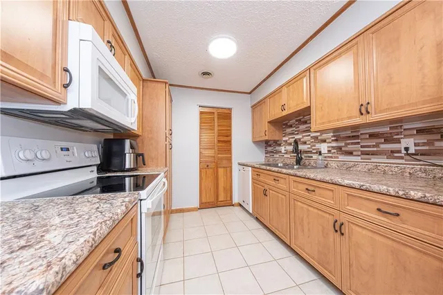 a kitchen with stainless steel appliances granite countertop a sink and cabinets