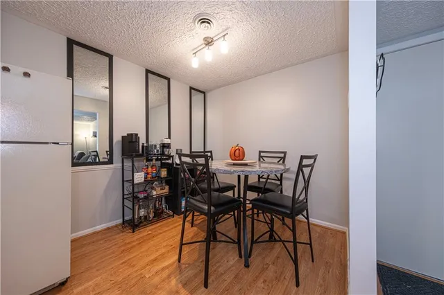 a view of a dining room with furniture and a chandelier