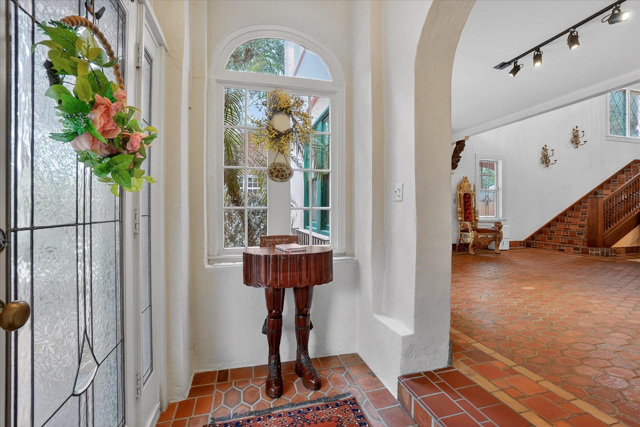 16 May Street St. Augustine, FL 32084 - Photo 12 of 85 Entrance foyer featuring track lighting, arched walkways, tile patterned flooring, and a textured wall