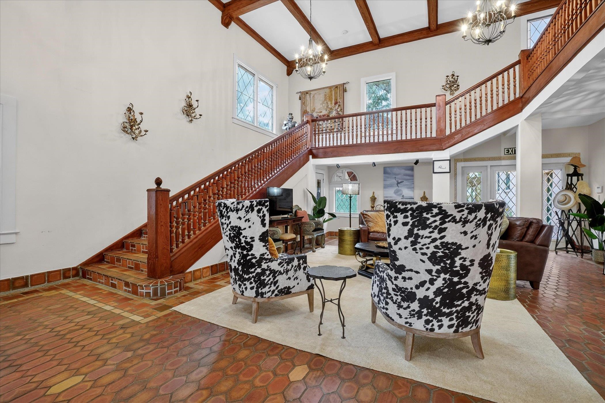 16 May Street St. Augustine, FL 32084 - Photo 15 of 85 Living area with stairs and a chandelier