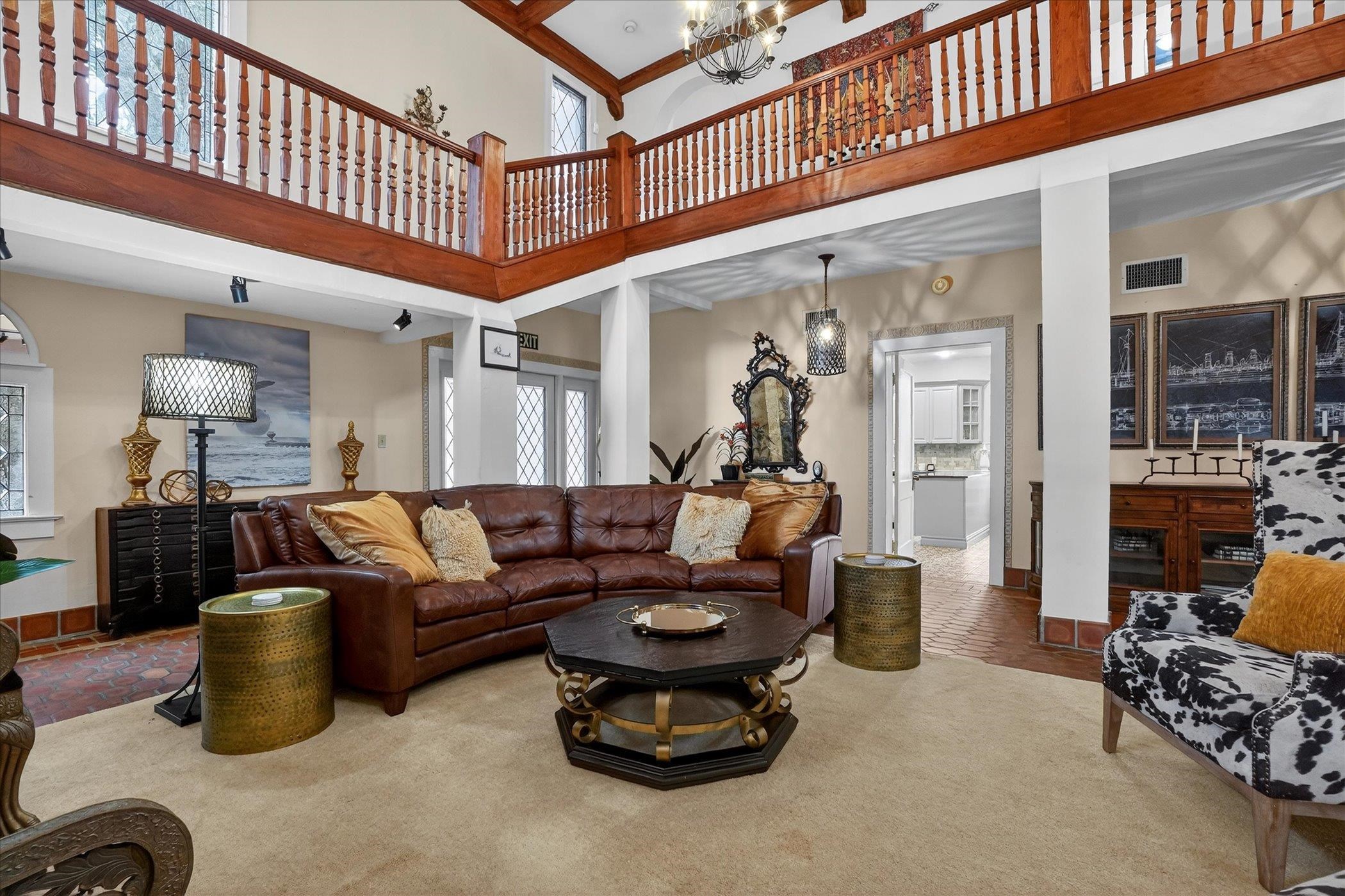 16 May Street St. Augustine, FL 32084 - Photo 19 of 85 Living room featuring a chandelier, french doors, a high ceiling, and carpet floors