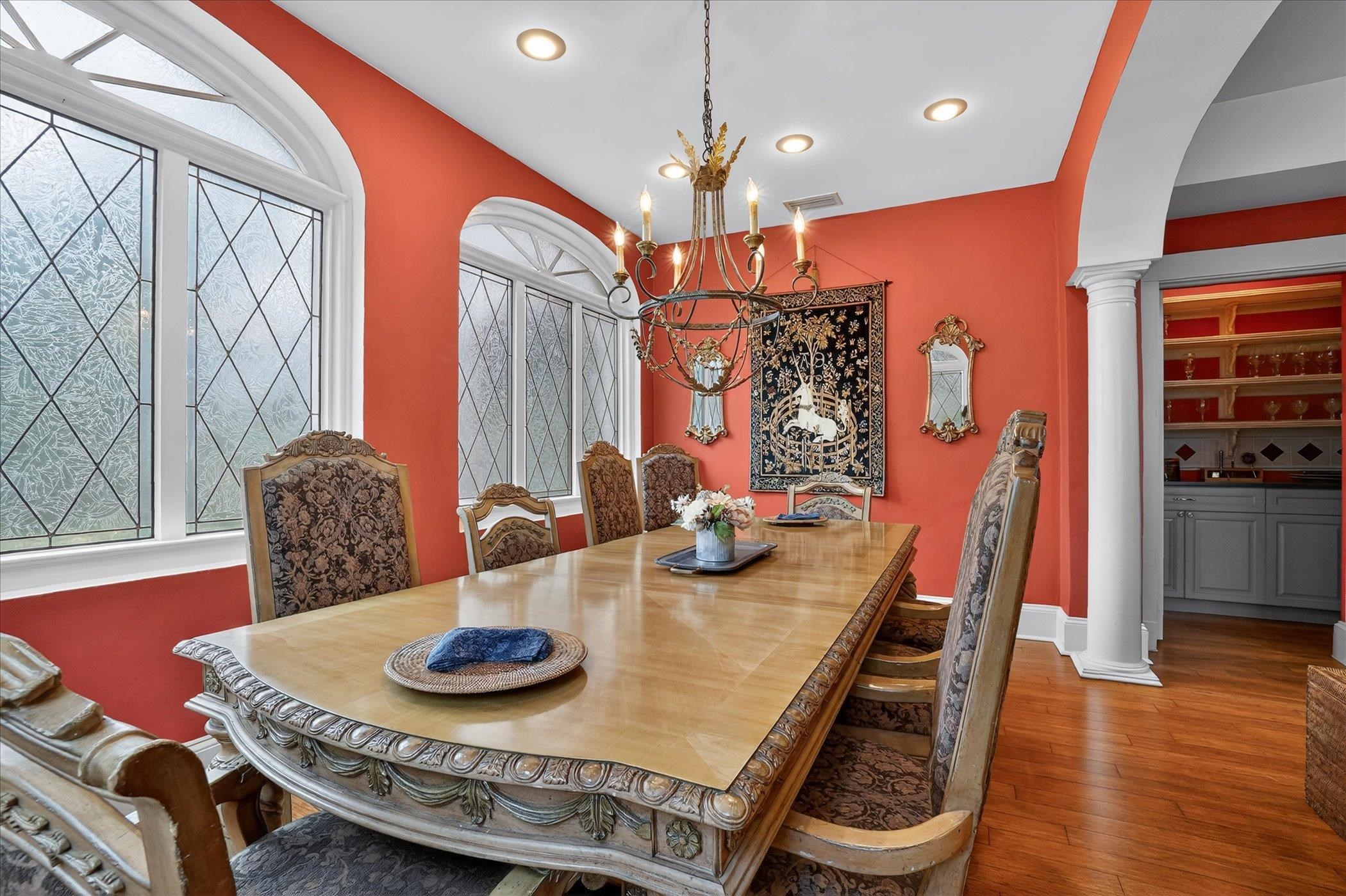 16 May Street St. Augustine, FL 32084 - Photo 29 of 85 Dining room with decorative columns, wood-type flooring, suspended lighting, and arched walkways