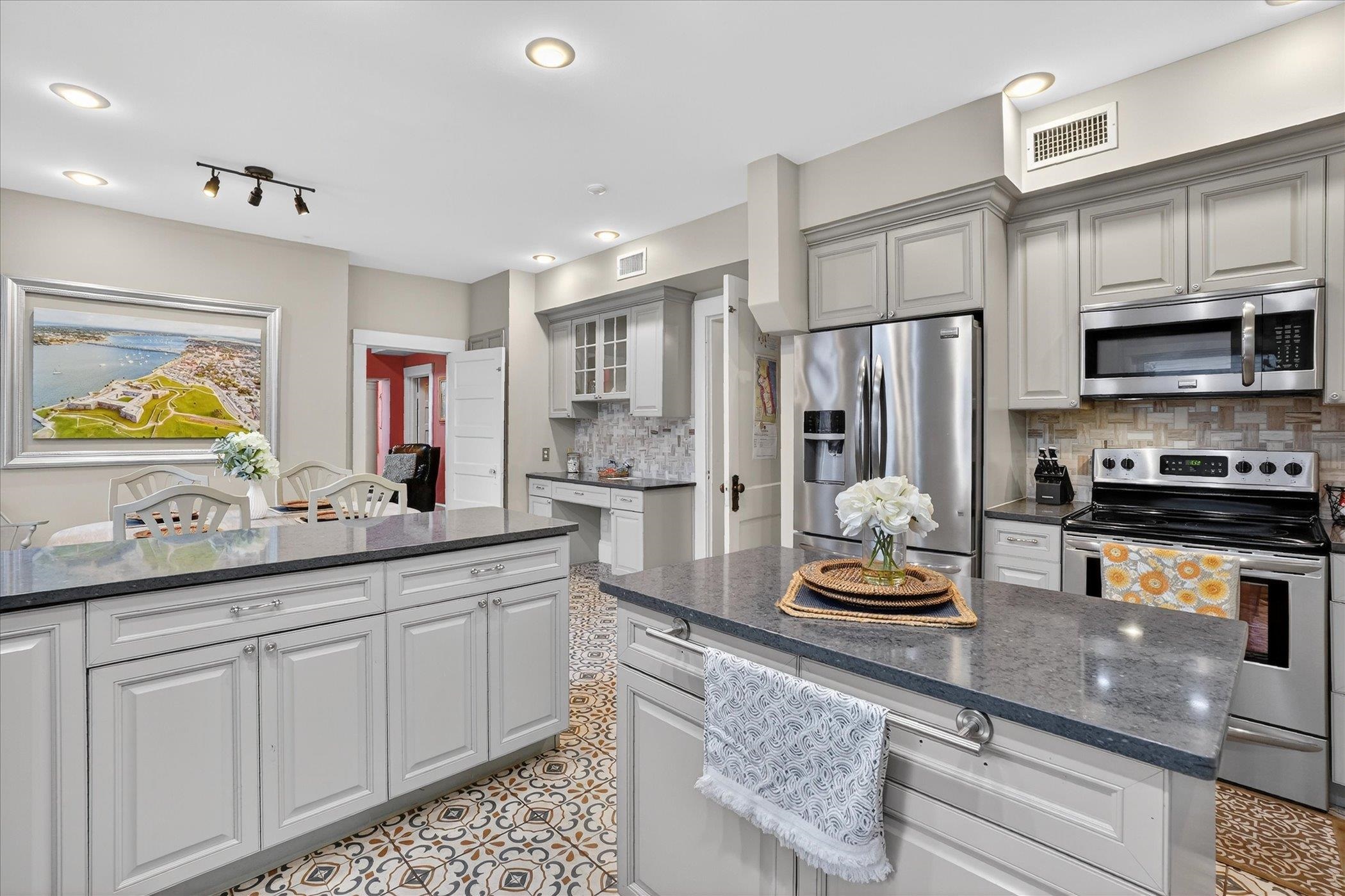 16 May Street St. Augustine, FL 32084 - Photo 34 of 85 a kitchen with stainless steel appliances granite countertop a sink stove and refrigerator