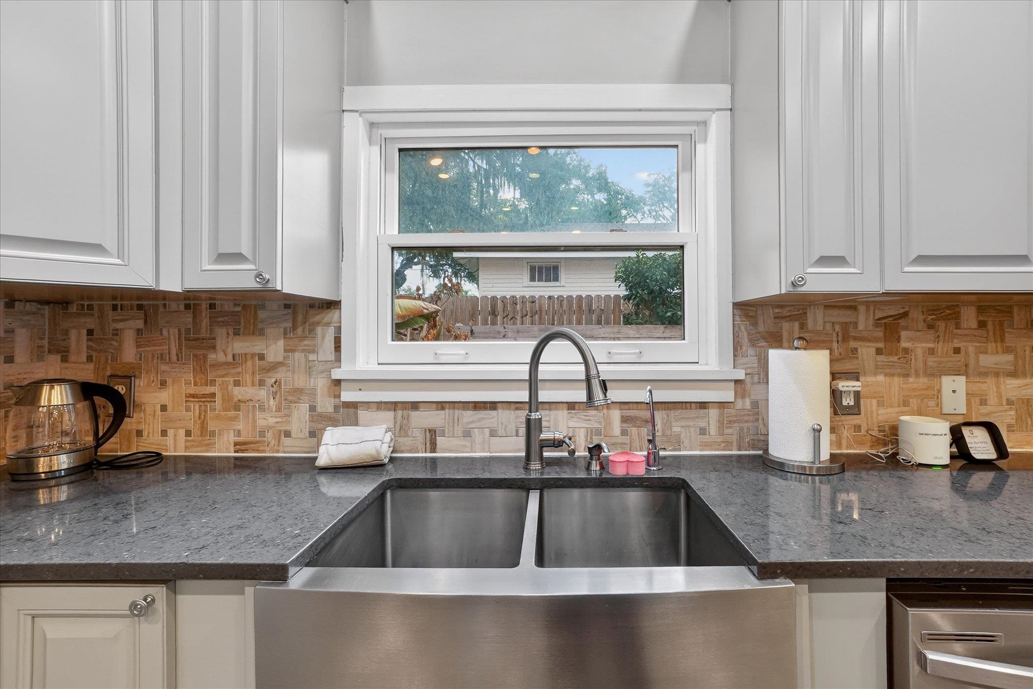 16 May Street St. Augustine, FL 32084 - Photo 35 of 85 Kitchen featuring dark stone countertops, white cabinetry, and stainless steel dishwasher