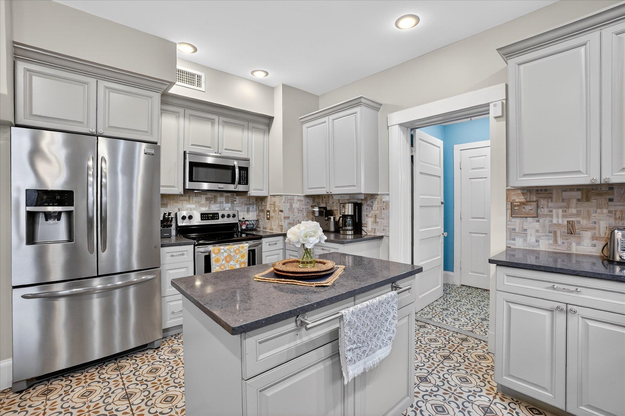 16 May Street St. Augustine, FL 32084 - Photo 36 of 85 Kitchen with stainless steel appliances, dark stone counters, and tasteful backsplash