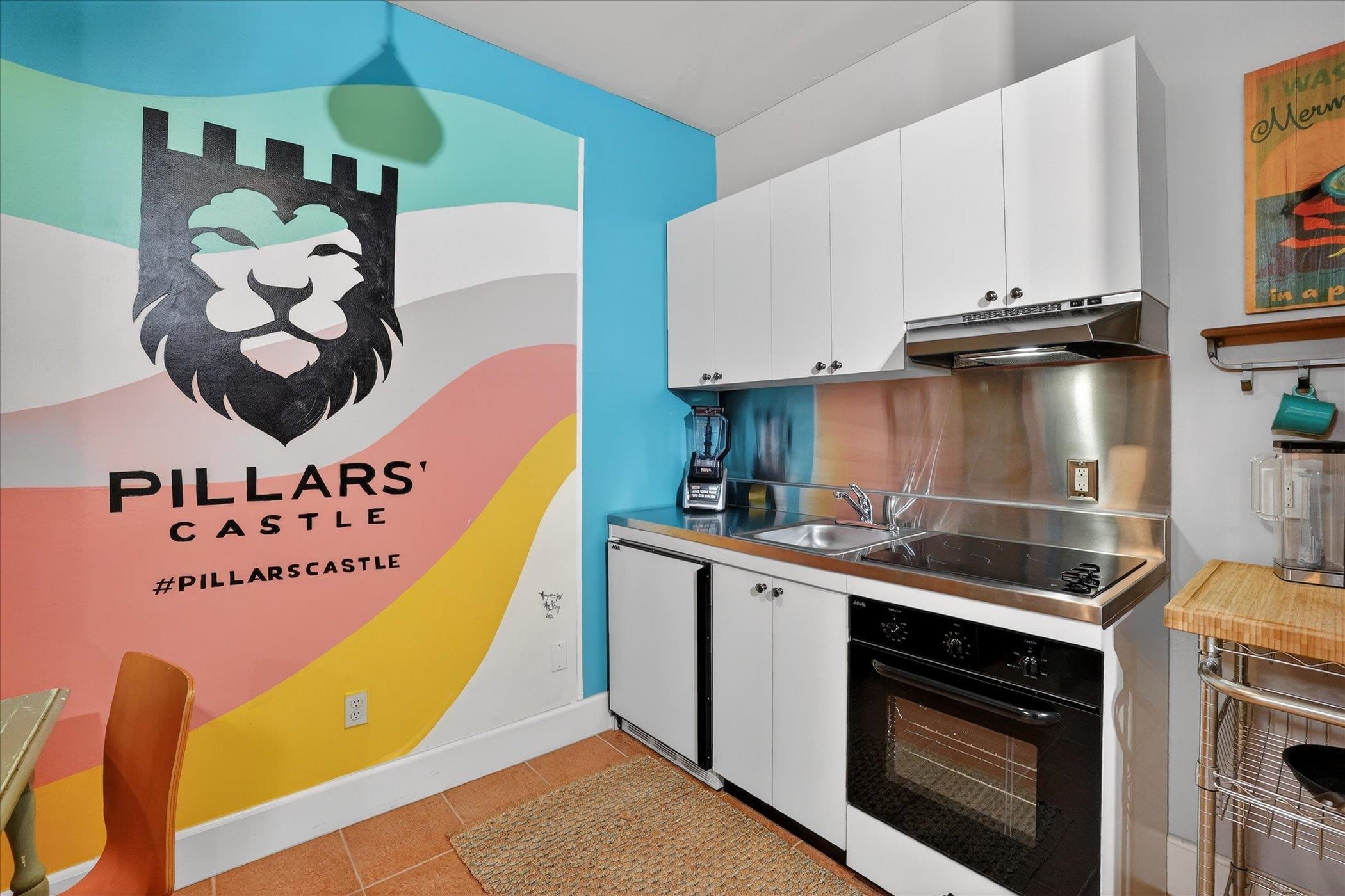 16 May Street St. Augustine, FL 32084 - Photo 44 of 85 Kitchen with white cabinets, black appliances, and light tile patterned floors