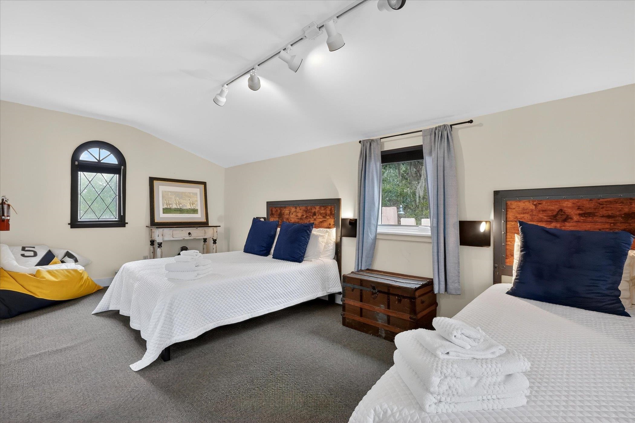 16 May Street St. Augustine, FL 32084 - Photo 56 of 85 Carpeted bedroom with vaulted ceiling, multiple windows, and track lighting