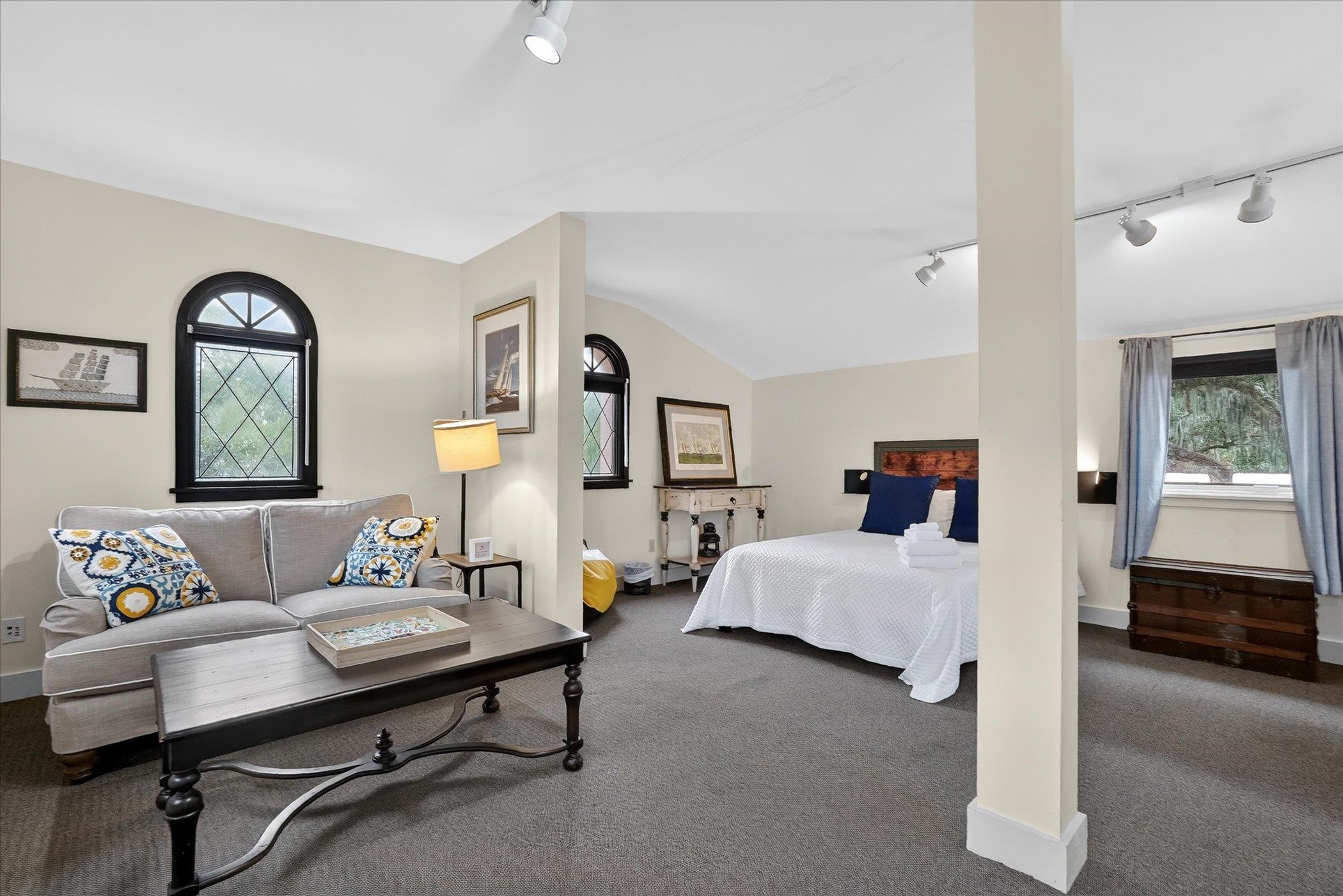 16 May Street St. Augustine, FL 32084 - Photo 58 of 85 Bedroom featuring rail lighting, carpet, and vaulted ceiling