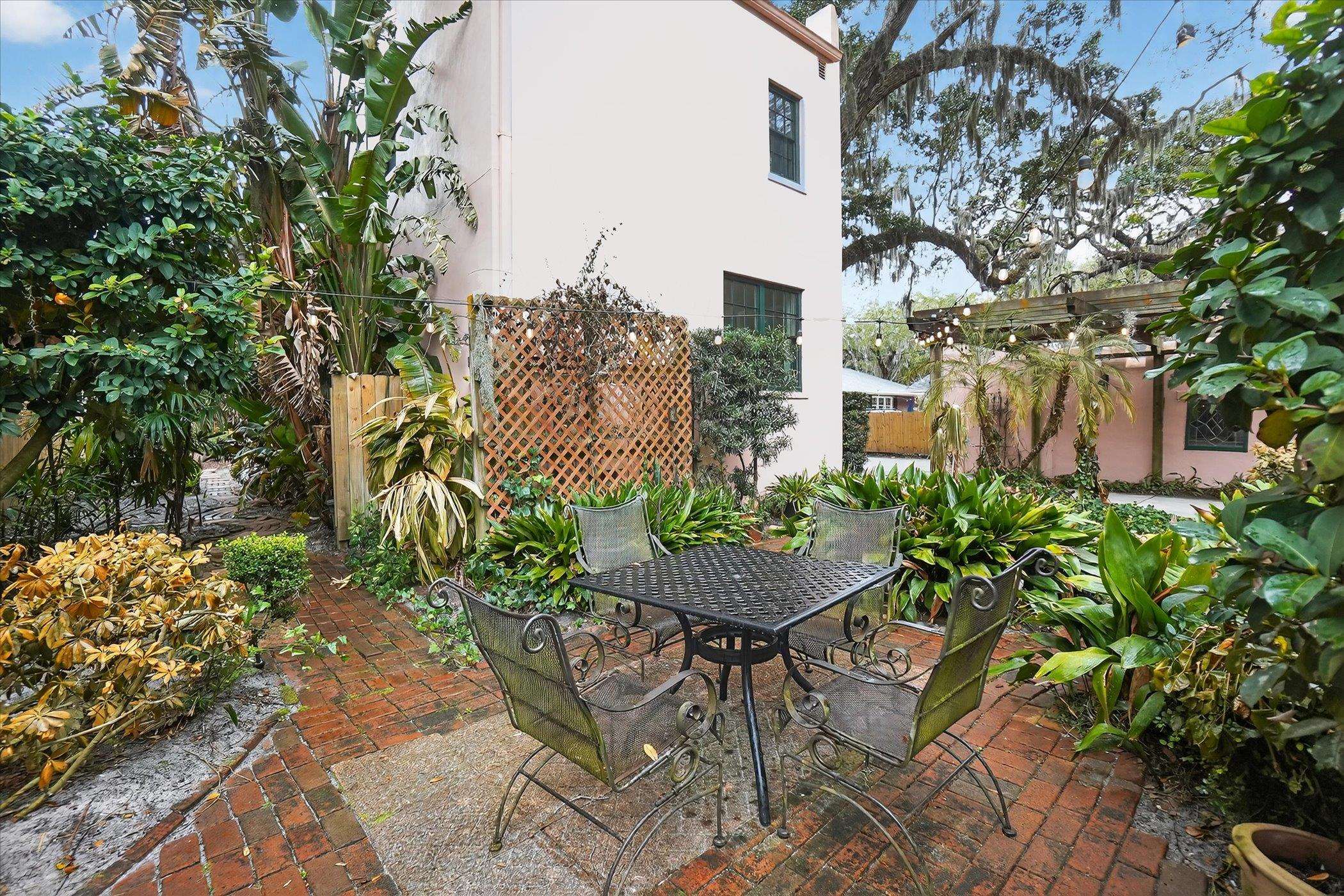 16 May Street St. Augustine, FL 32084 - Photo 5 of 85 a view of a patio with table and chairs and potted plants