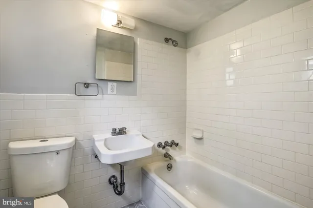 a bathroom with a sink a toilet and bathtub