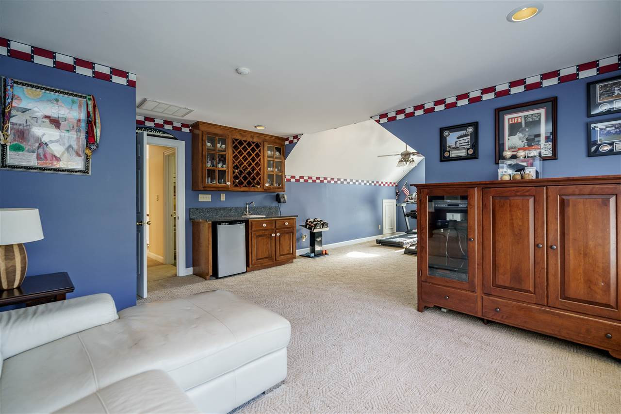 1028 Mersey Lane Raleigh, NC 27615 - Photo 23 of 30 Bonus Room with cabinets, wet bar, ceiling fan, wired speakers, dual sitting areas and carpet floors. Bonus Room
