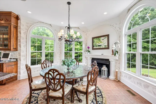 a living room with fireplace furniture and a large window