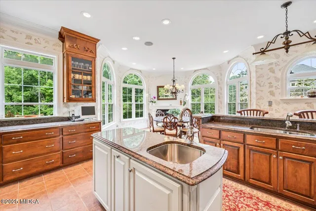 a very nice looking dining room with a large window and stainless steel appliances