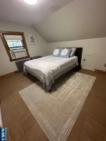 a bedroom with a bed lamp and a dresser