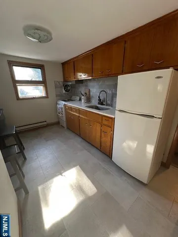a kitchen with stainless steel appliances a refrigerator sink and cabinets