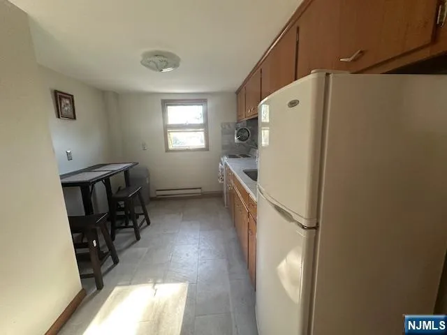 a utility room with wooden floor washer and dryer
