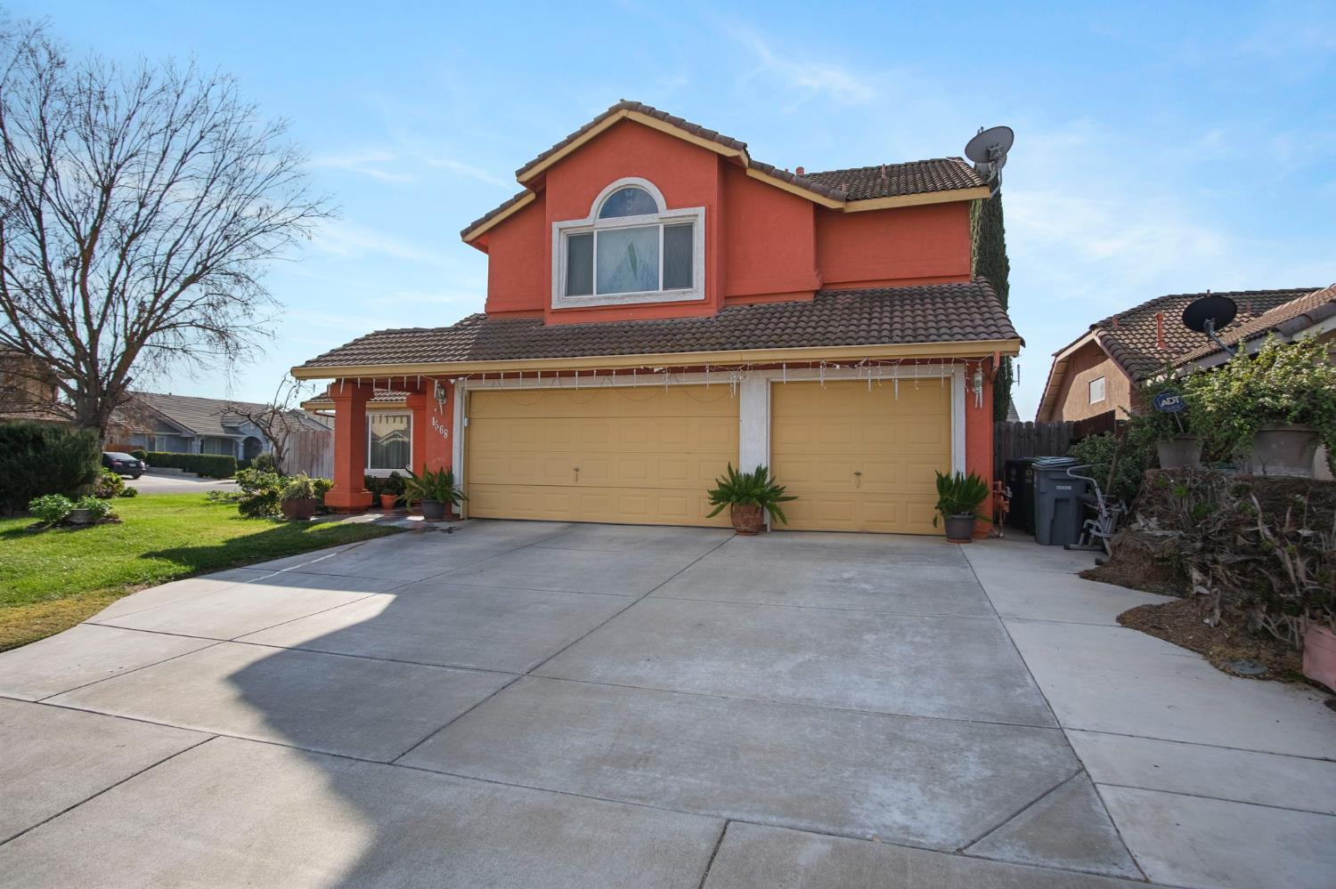1568 Vía Del Pettoruto Gustine, CA 95322 - Photo 1 of 30 a front view of a house with a yard and garage