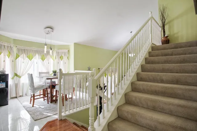 a bedroom with a bed dresser and a chair