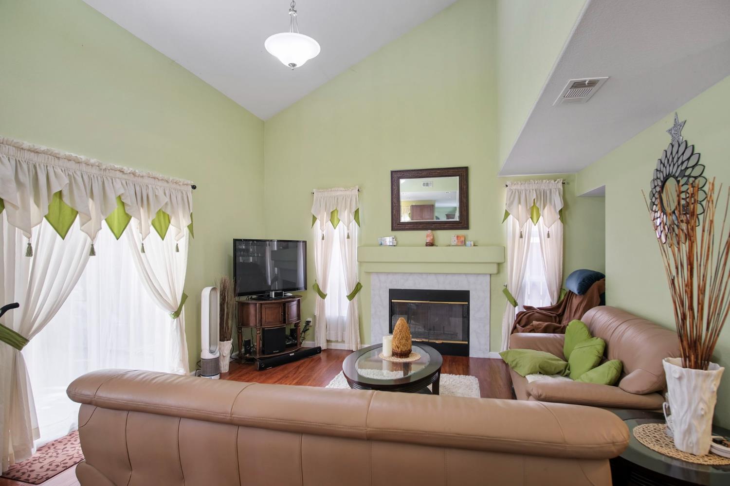 1568 Vía Del Pettoruto Gustine, CA 95322 - Photo 16 of 30 a living room with furniture and a fireplace