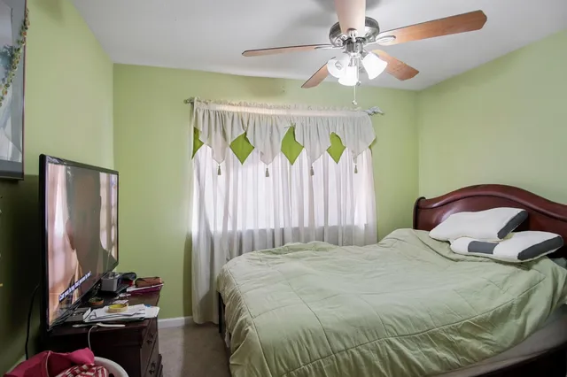 a bedroom with a bed a desk and chair