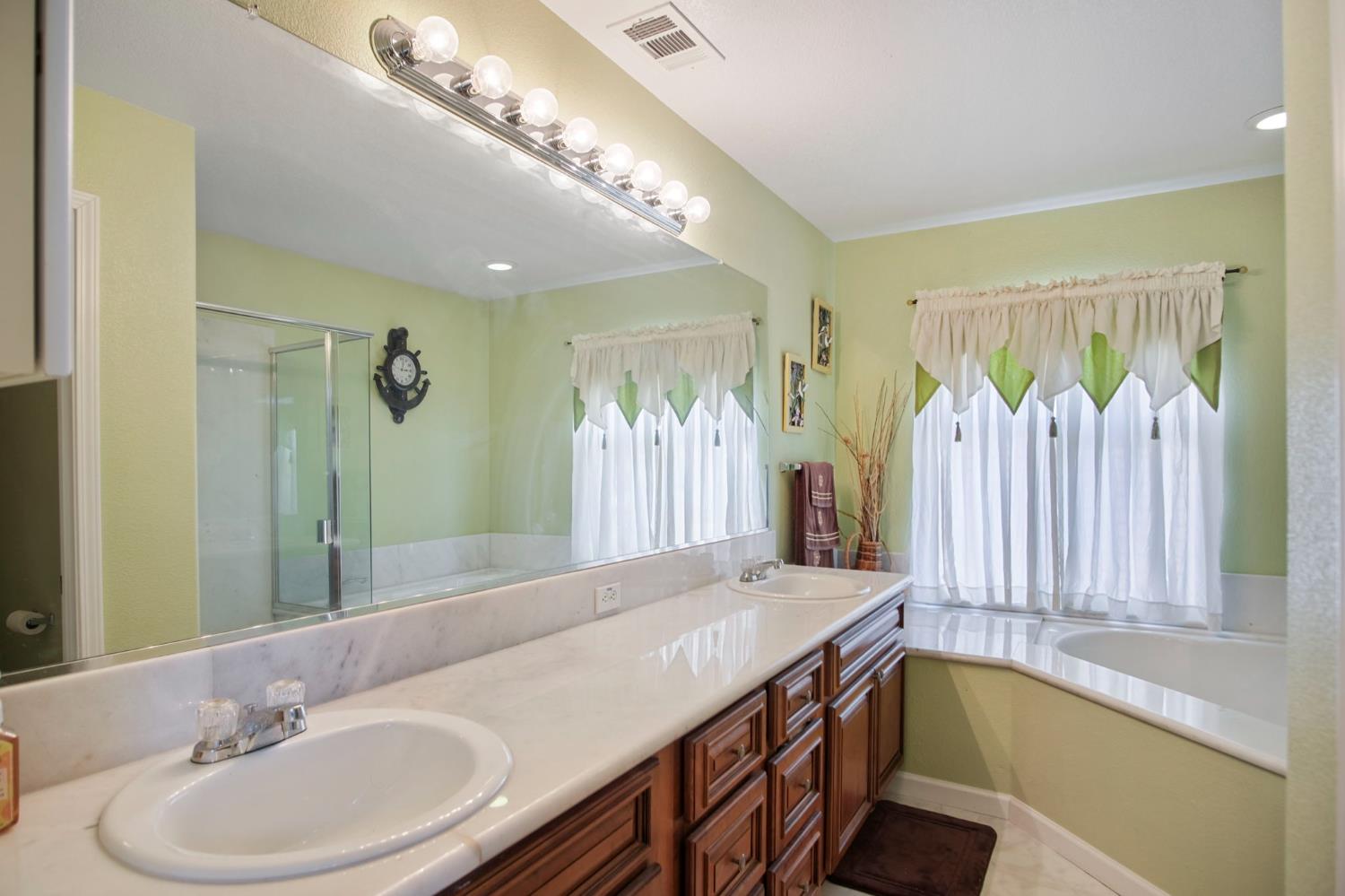 1568 Vía Del Pettoruto Gustine, CA 95322 - Photo 25 of 30 a bathroom with a sink and a mirror