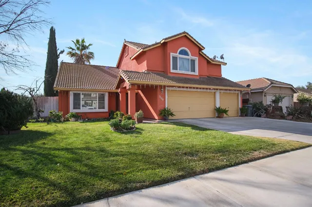 a front view of a house with a yard and garage