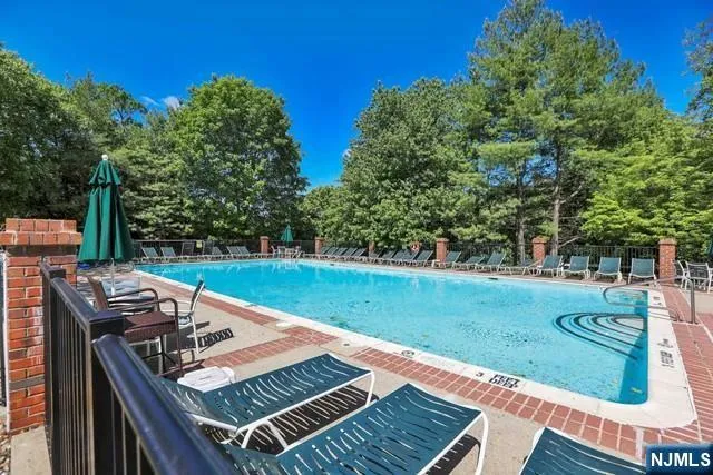 a view of a wooden deck and a backyard