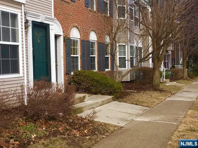 a view of a brick building next to a yard