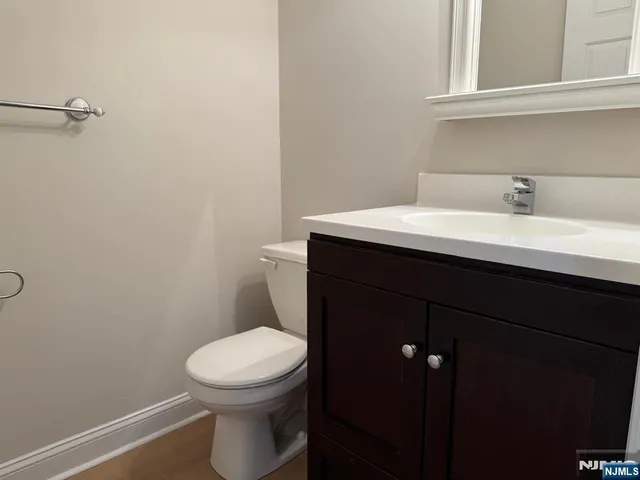 a bathroom with a sink a toilet and a mirror