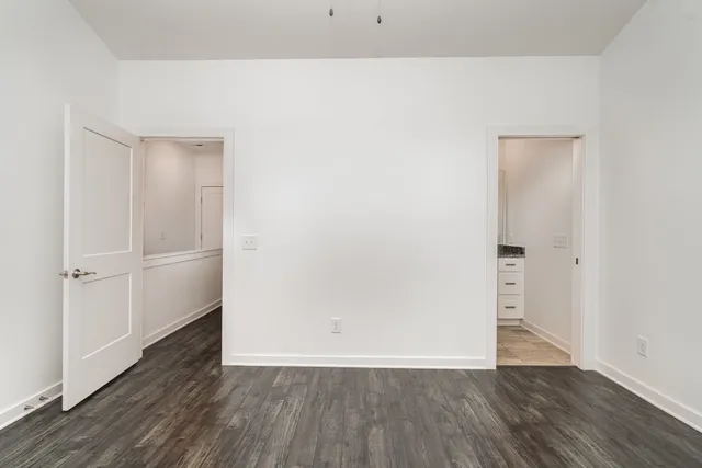 a bathroom with a granite countertop sink a mirror and a bathtub