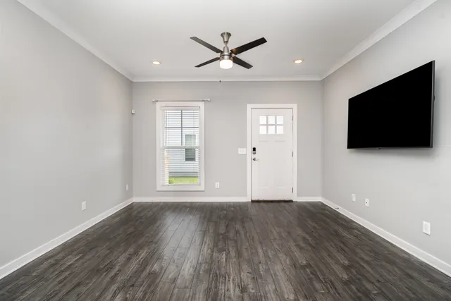 a living room with fireplace furniture and a flat screen tv
