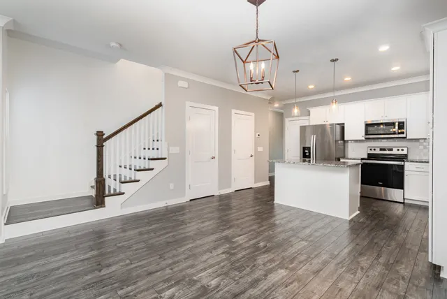 a kitchen with stainless steel appliances a refrigerator and a stove top oven